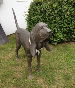 This serious-looking canine statue stands guard over the parking lot.