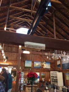 You can see some of the paintings for sale, and also a sign on the beam that never fails to amuse my husband.